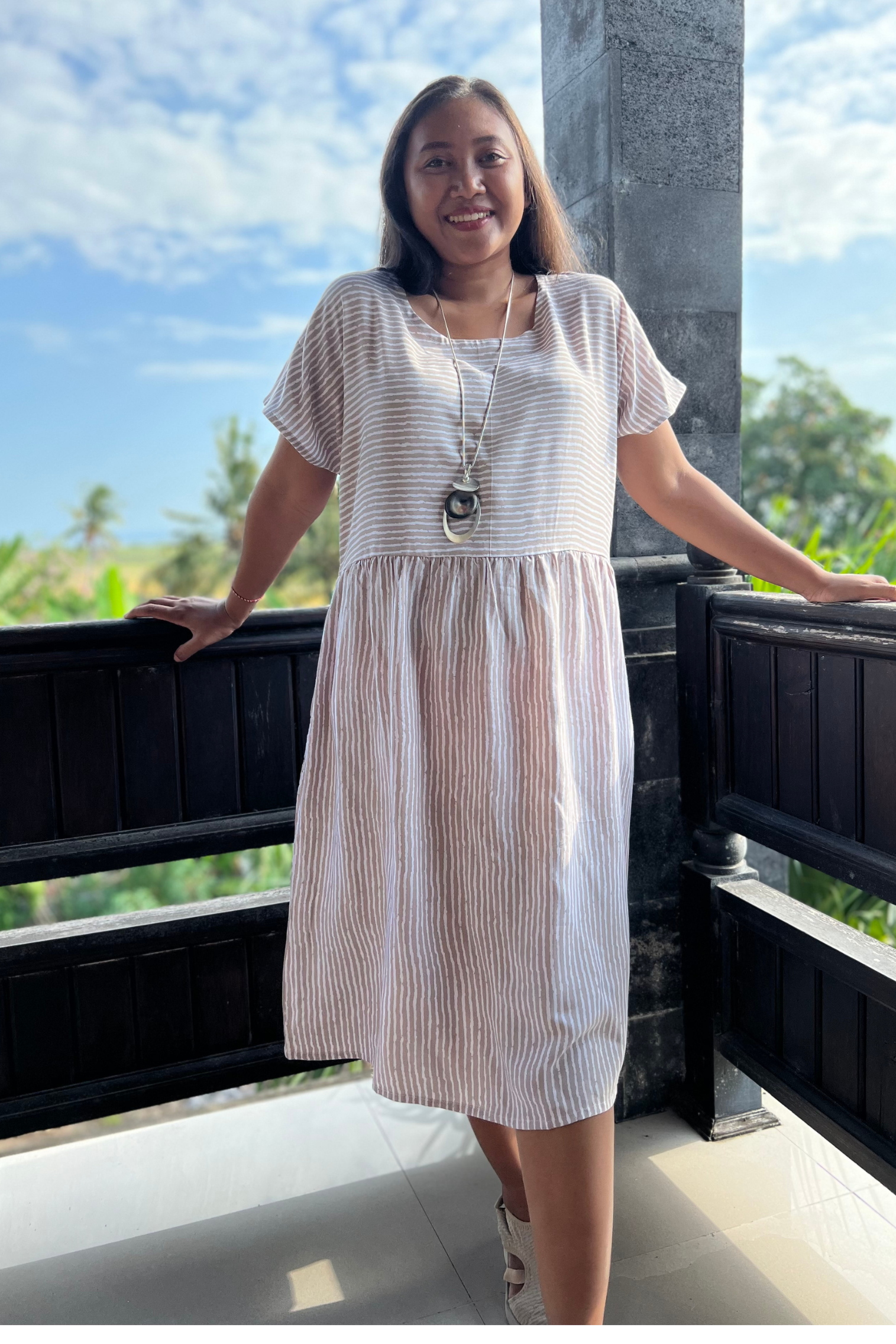 Kita Ku model wearing a simple babydoll style shift LULU dress in mocha and white stripe