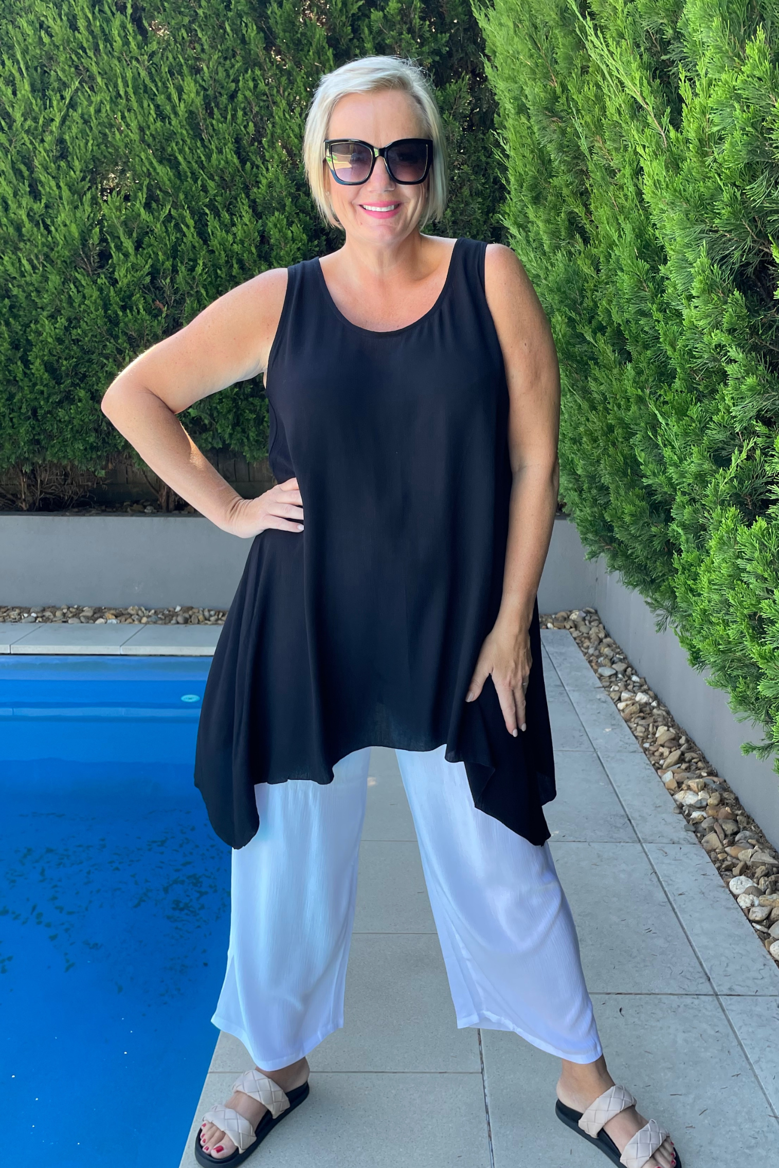 kita ku modelling the longline scoop tunic axel in black over wide leg white pant