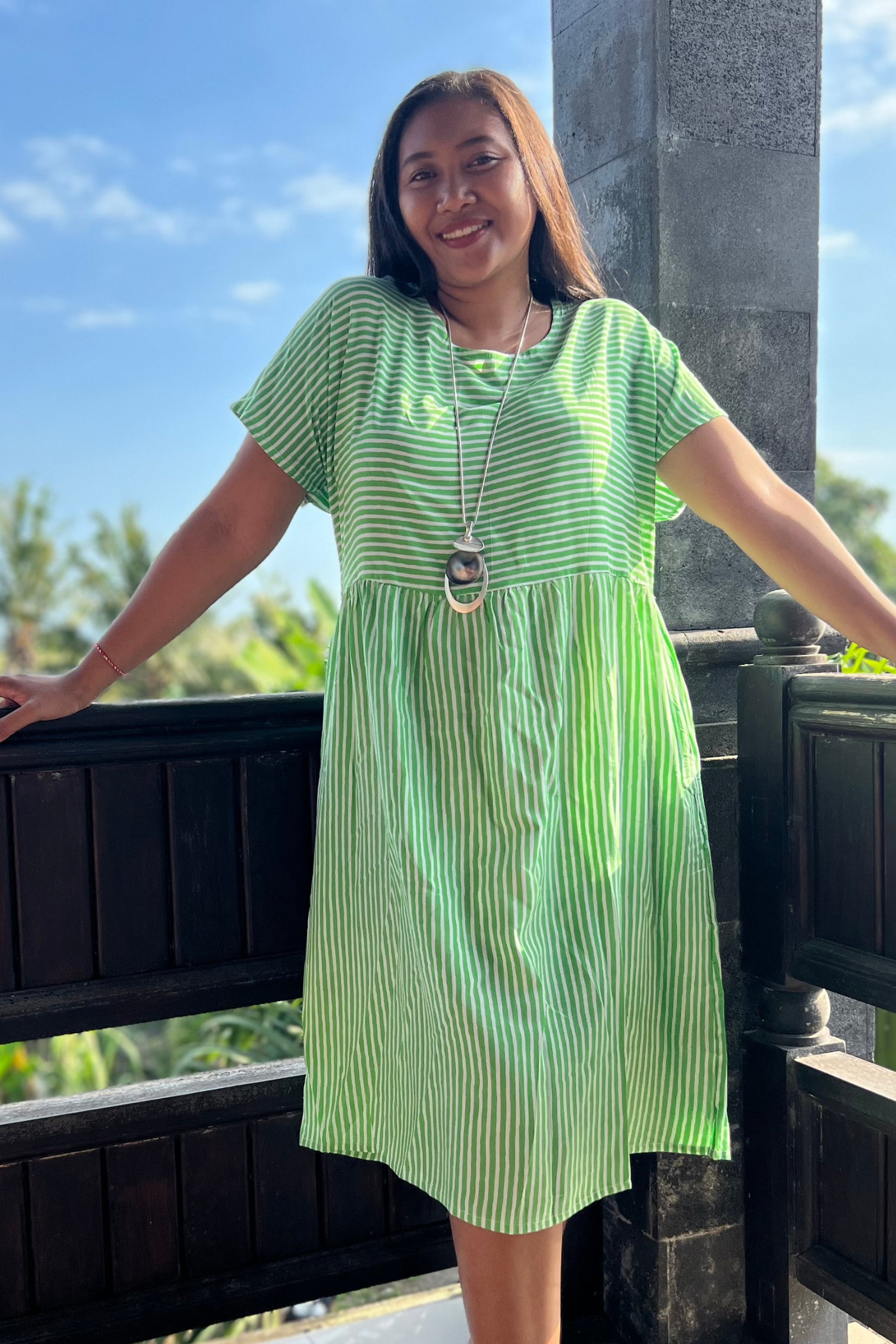 Kita Ku model wearing the dress Lulu in a lime stripe fabric