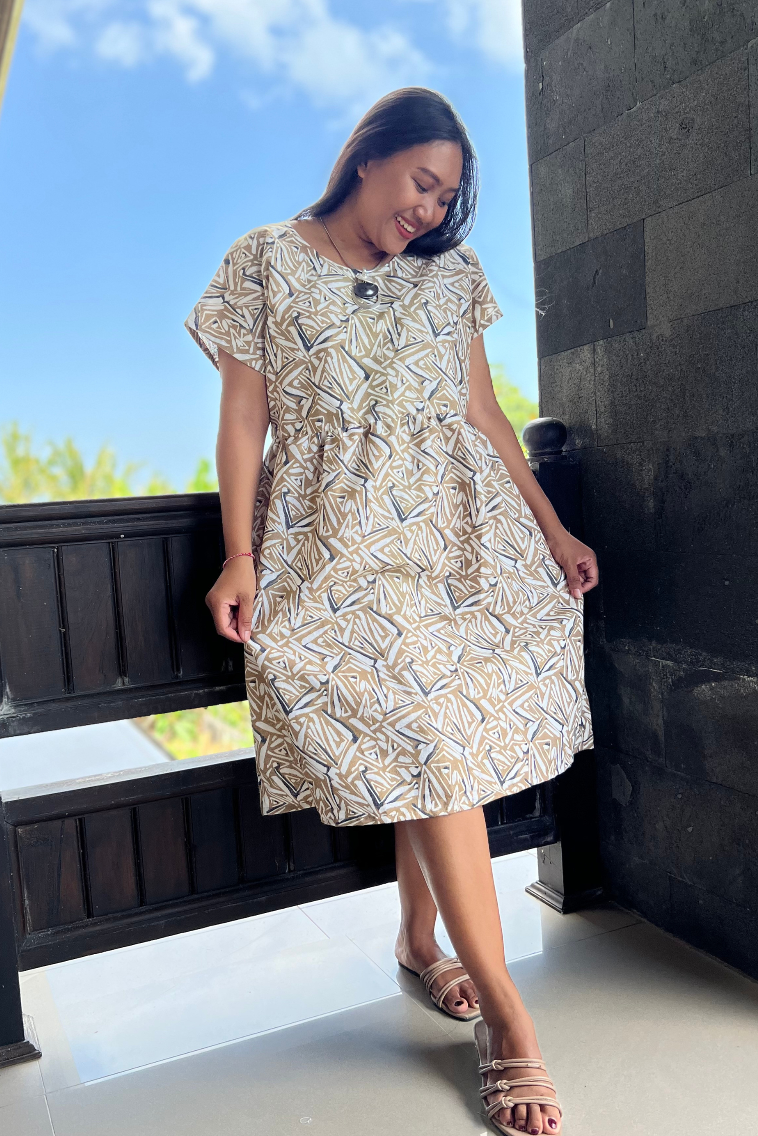 Kita Ku model wearing a linen natural and mustard abstract printed dress