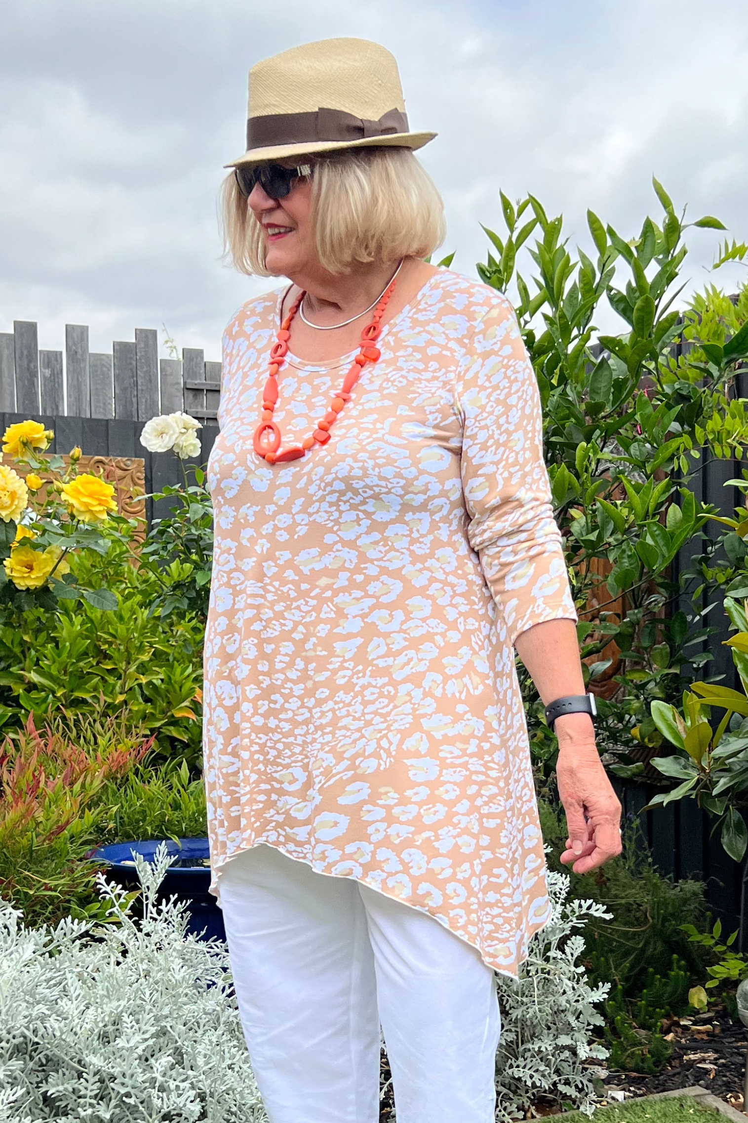 Kita Ku modelling a stretch jersey animal printed top Scoop in a garden setting.