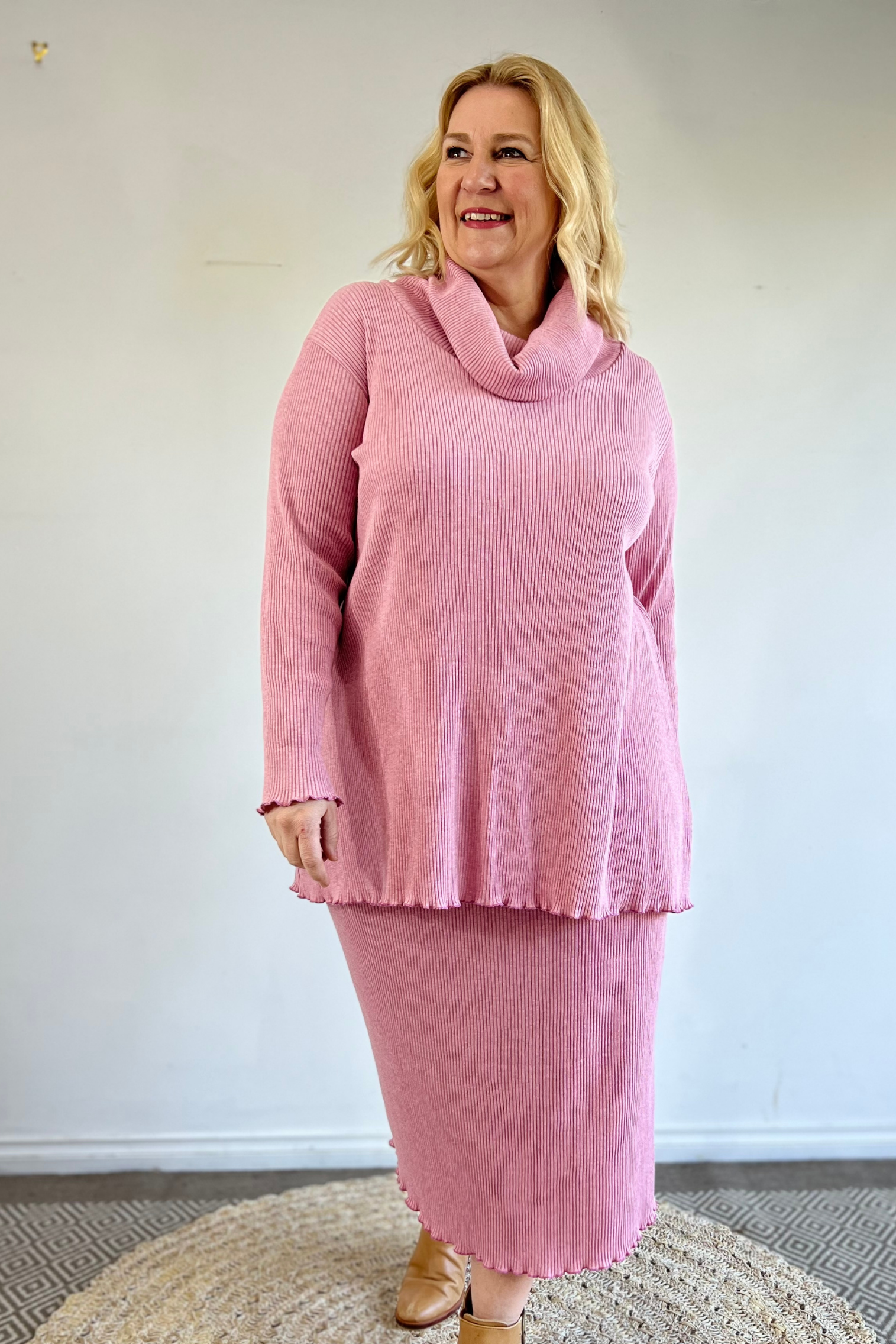 blonde kita ku model wearing a skirt in pink rib cotton with a top to match. 